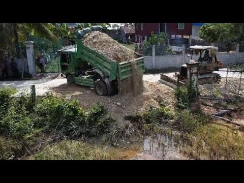 Dump Truck Unloading Soil at a Residential Construction Site
