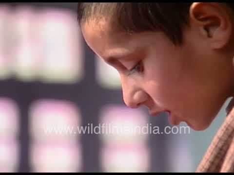 Young Kashmiri Kid in traditional Attire Reading Aloud
