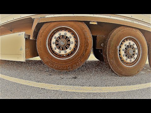Why does a semi-trailer (truck) have a raised axle?