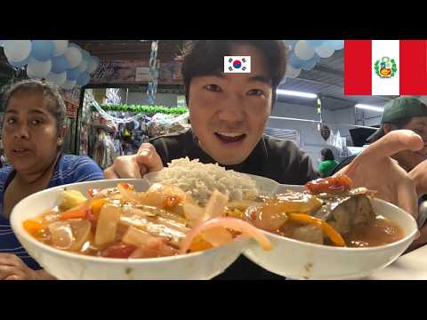 Korean man trying fish stew for the first time in Lima, Peru