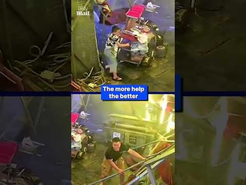 Restaurant owner holds down tent during storm