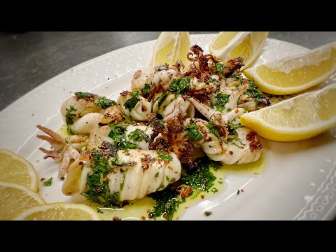 Pan-fried squid - seafood in olive oil with garlic, parsley, basil and lemon.