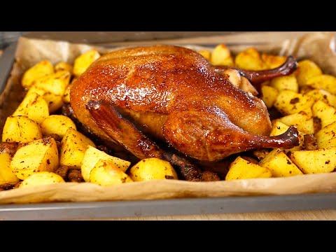 Baked duck with apples, potatoes, and mushrooms. Oven-baked duck.