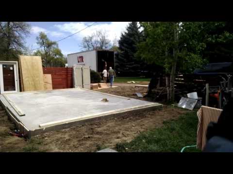 Unloading a 352 square foot Studio Shed kit from the delivery truck