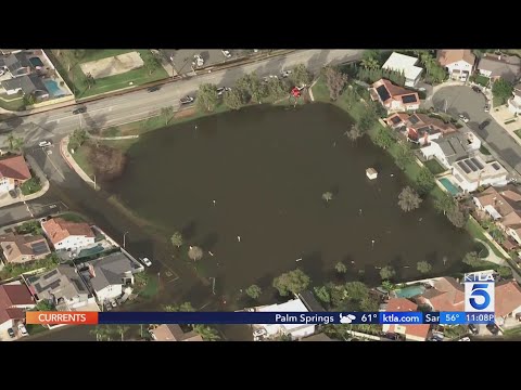 Torrential rains flood streets of Huntington Beach neighborhood