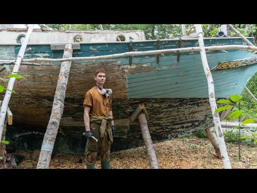 Removing decades of paint from old wooden sailboat in the forest - no. 16