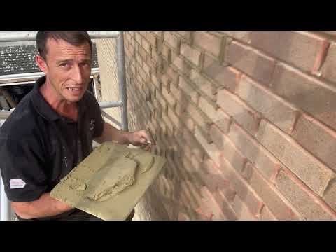 REPOINTING BRICKWORK using a hawk and trowel.